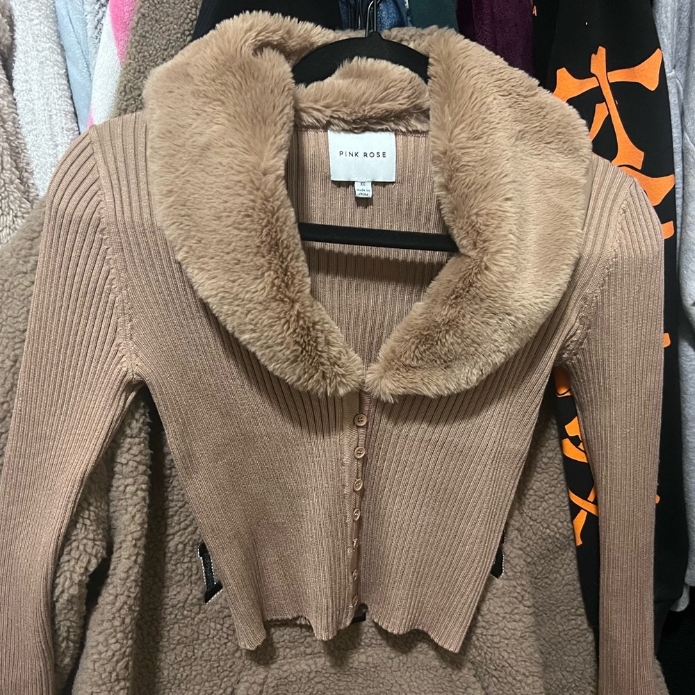 A brown botton down with soft fur around the neck ,no tag but is brand new